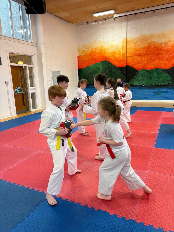 Children practising karate pad work at JKS Clyde in Garelochhead